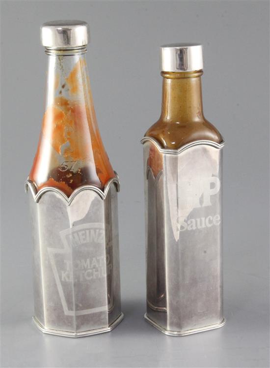 Two modern Theo Fennell silver sauce bottle holders and lids, for HP Sauce and Heinz Ketchup,